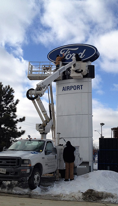 ford-2 installing sign face using bucket